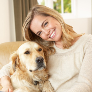 Happy woman with golden retreiver dog