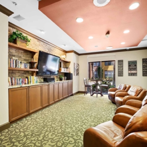 Alternate view of Movie room for residents at Visconti with leather lounge seating and flat screen tv