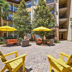 Alternate view of Courtyard with lounge patio furniture covered by bright yellow umbrellas