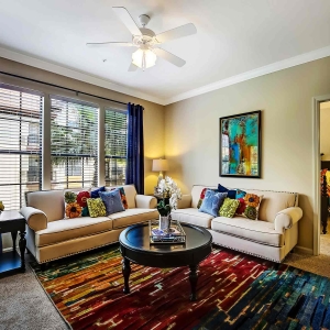 Beautifully furnished large living area in model home at Visconti with large windows and lots of natural light